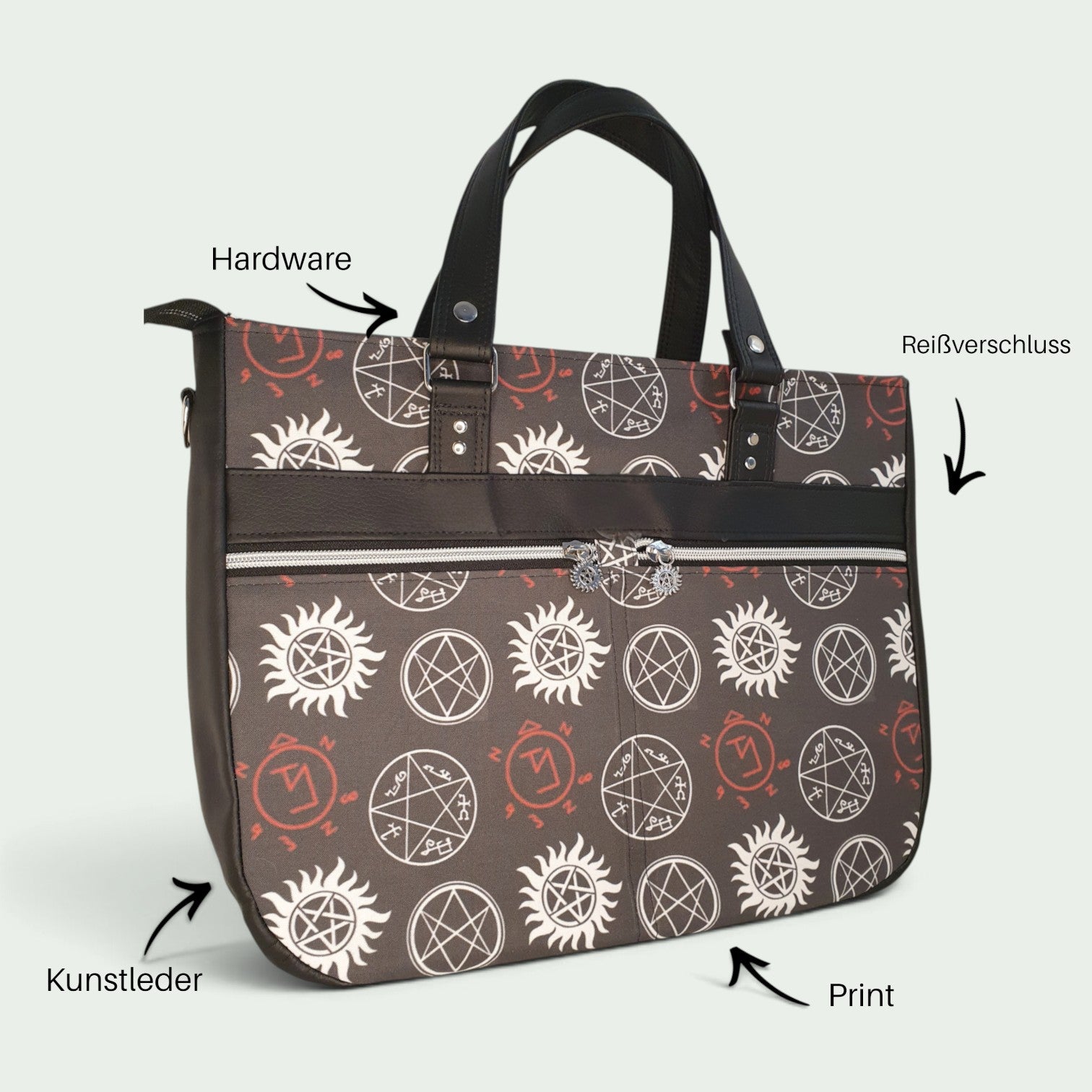 Schneckenschmiede Handtasche Divina mit okkultem Muster, schwarzen Kunstlederdetails und zwei Fronttaschen