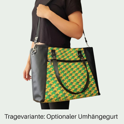 Schneckenschmiede Everyday Shopper Handtasche mit grün-gelbem Muster, Kunstleder-Details und praktischem Umhängegurt.