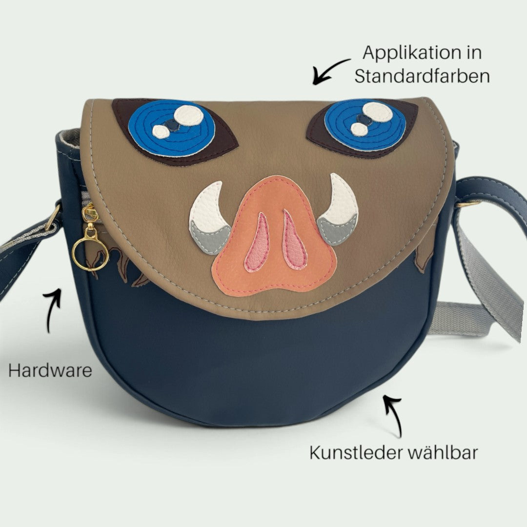Schneckenschmiede Inoshishi Umhängetasche aus Kunstleder mit Wildschweinmasken-Applikation und verstellbarem Gurt