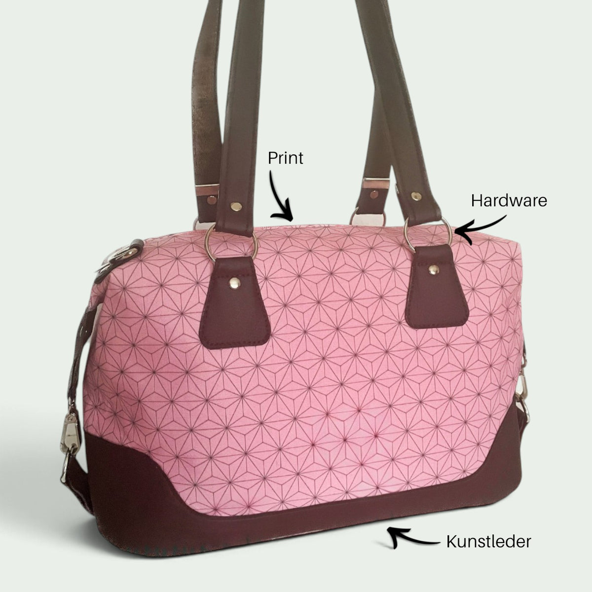 Schneckenschmiede Brooklyn Umhängetasche in Rosa mit geometrischem Muster, braunen Kunstleder-Akzenten und Metallringen